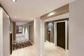 a hallway with white walls and a wooden floor